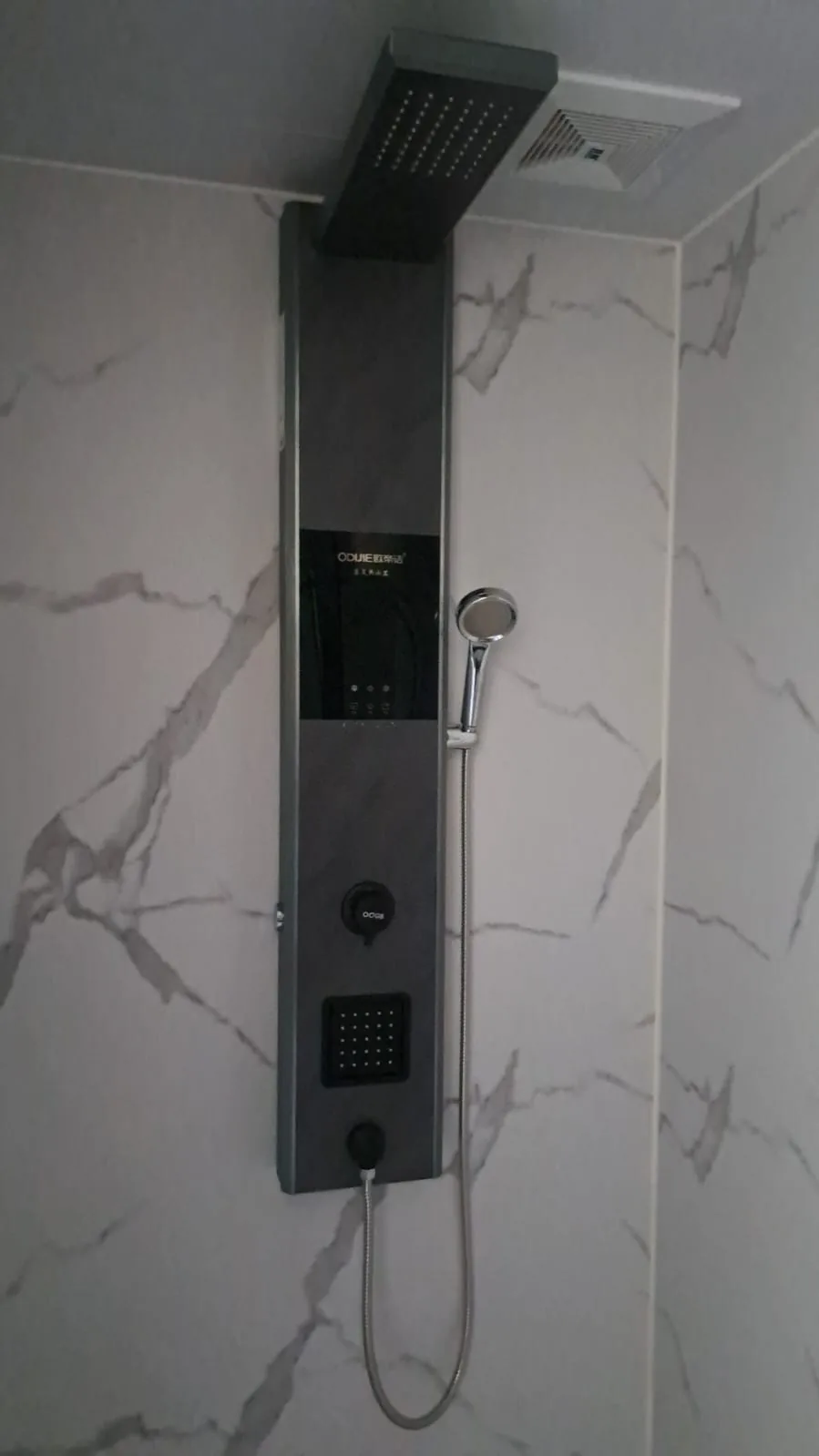 A walk-in shower with marble-effect wall panels